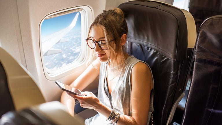 A woman finding best ways to using iphone internationally while she is traveling abroad 