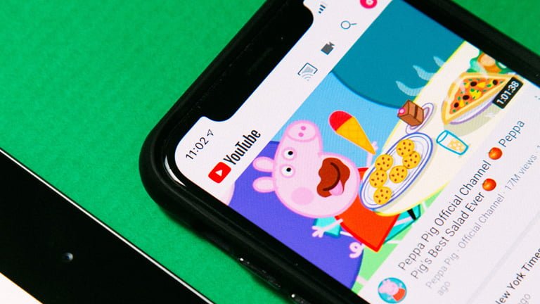 A smartphone screen with YouTube video Peppa Pig official channel